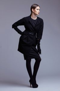 high fashion portrait of elegant woman in black coat. Studio sho